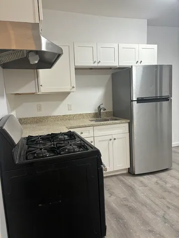 a kitchen with a stove and a refrigerator