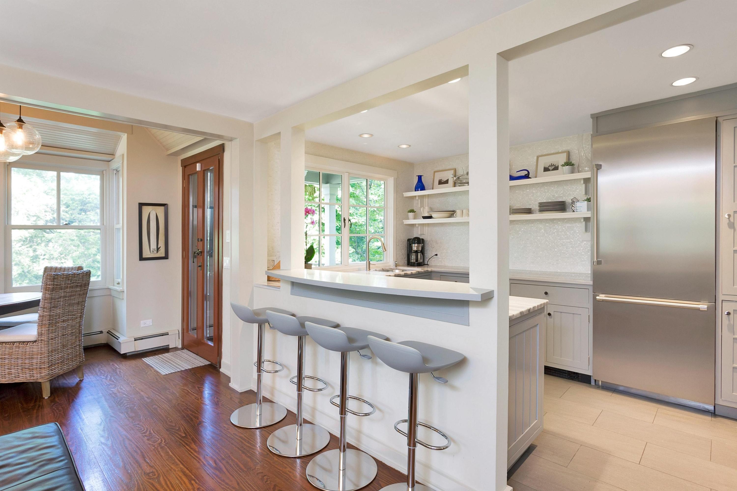 12 Crest Road Rowayton, CT 06853 - Photo 11 of 35 a kitchen with stainless steel appliances granite countertop a refrigerator and wooden cabinets