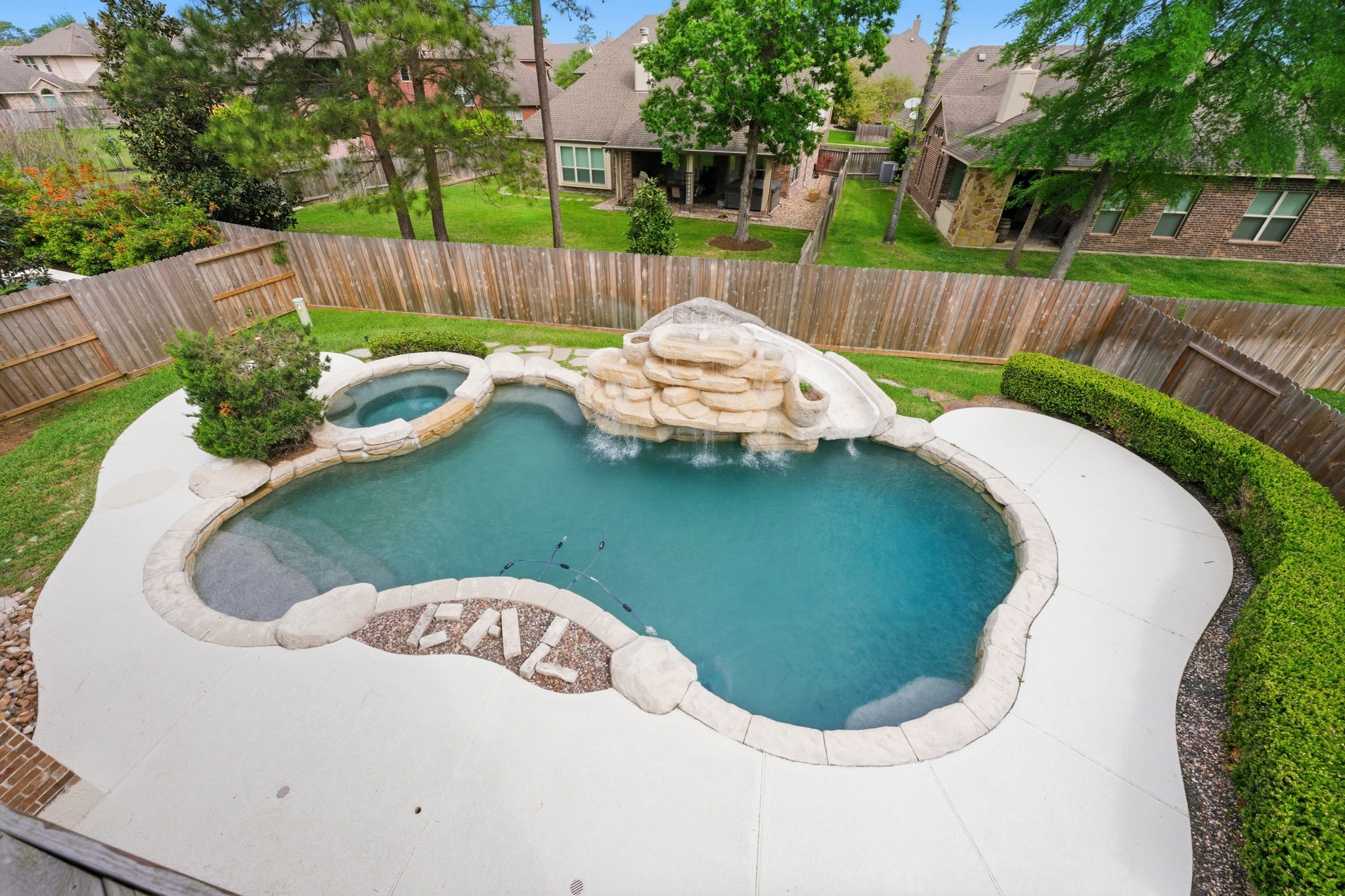315 Arbor Ridge Lane Conroe, TX 77384 - Photo 12 of 48 a view of a wooden fence with a swimming pool