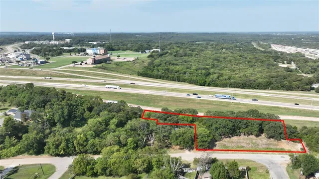 a view of a town with an ocean and trees
