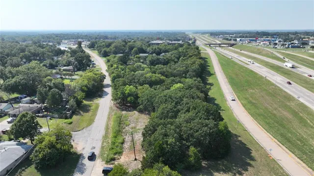 an aerial view of residential houses with outdoor space and river
