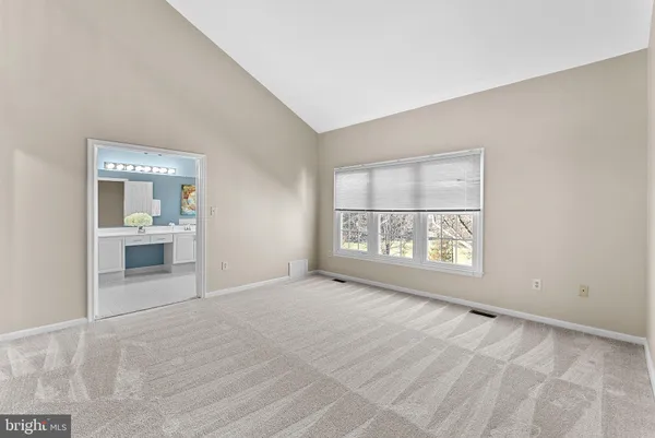 a bathroom with a tub a sink and a large mirror