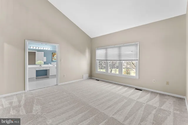 a bathroom with a tub a sink and a large mirror