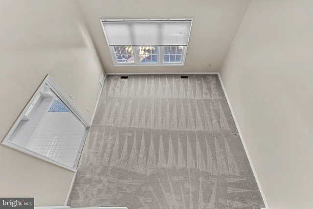 a view of an empty room with a fireplace