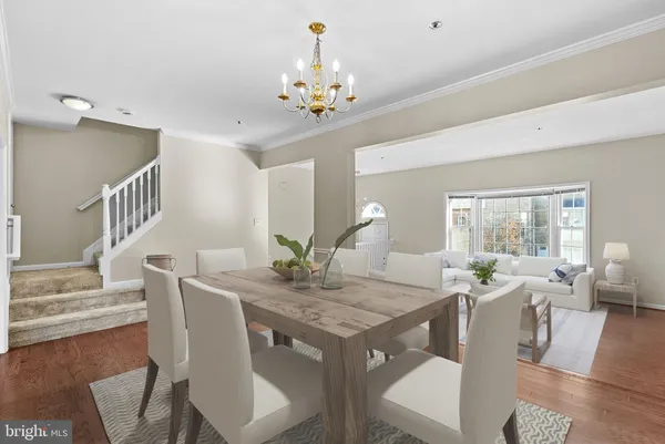 an empty room with wooden floor and chandelier fan