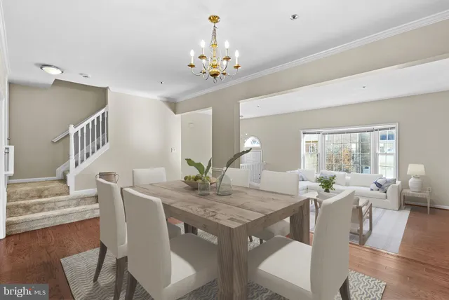 an empty room with wooden floor and chandelier fan