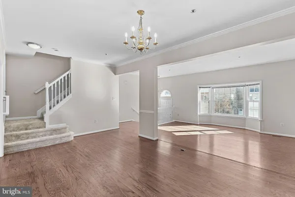a kitchen with a dining table chairs refrigerator and microwave