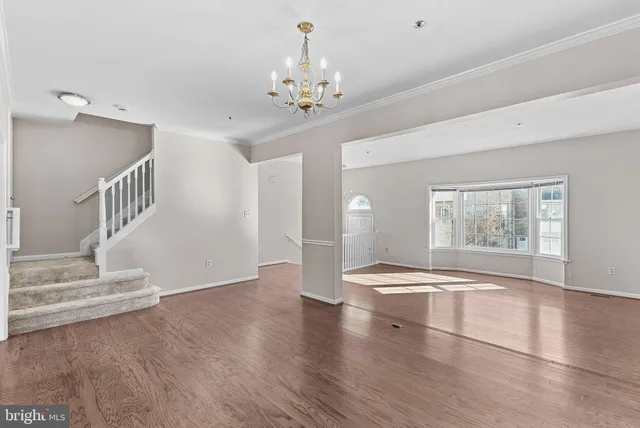 a kitchen with a dining table chairs refrigerator and microwave
