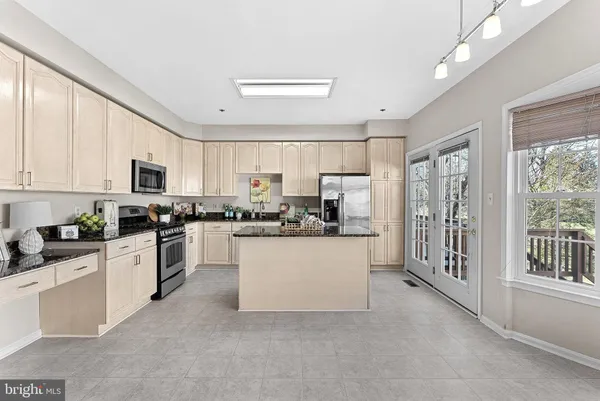 a large white kitchen with window