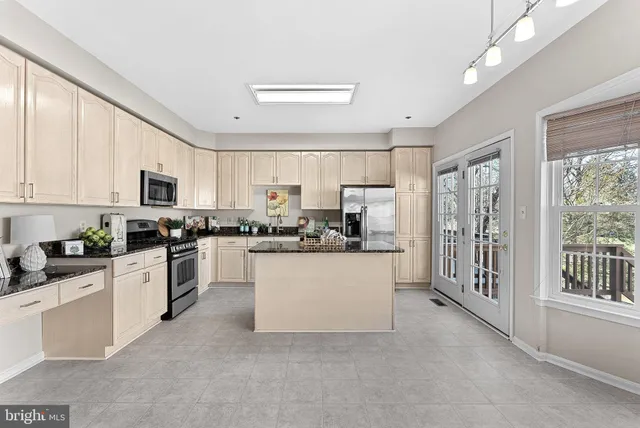 a large white kitchen with window