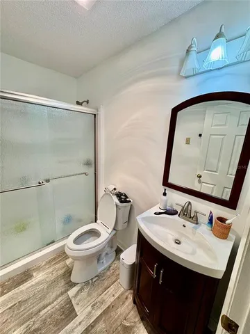 a bathroom with a sink toilet and mirror