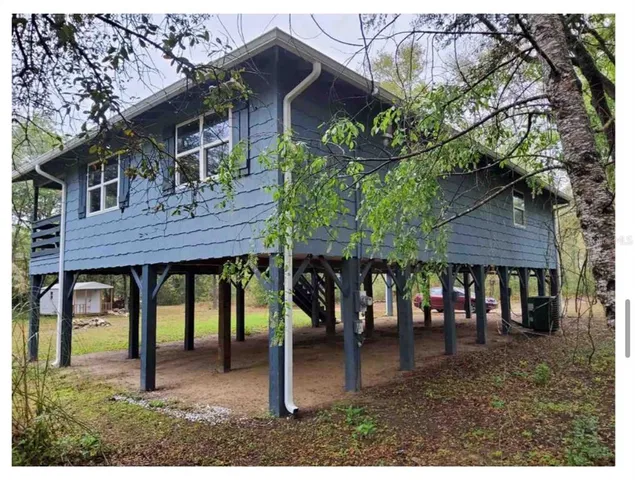 a backyard of a house with table and chairs