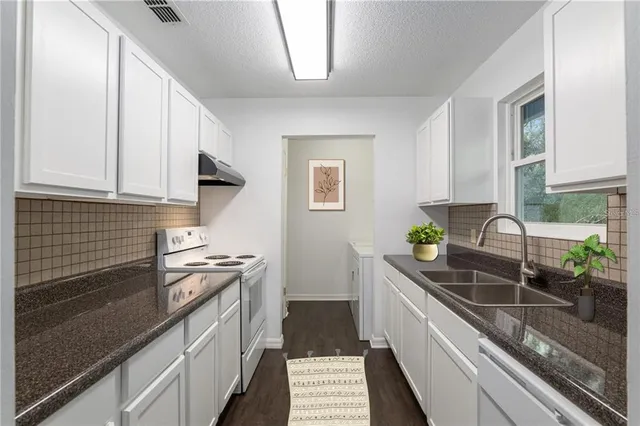 a kitchen with a sink and cabinets