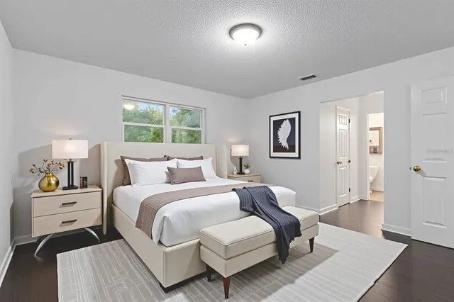 a bedroom with a bed and a couch