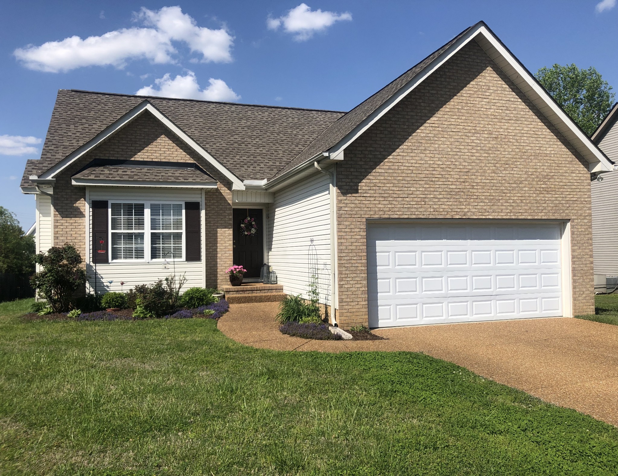 1003 Patterson Street Spring Hill, TN 37174 - Photo 3 of 27 a front view of a house with a yard and garage