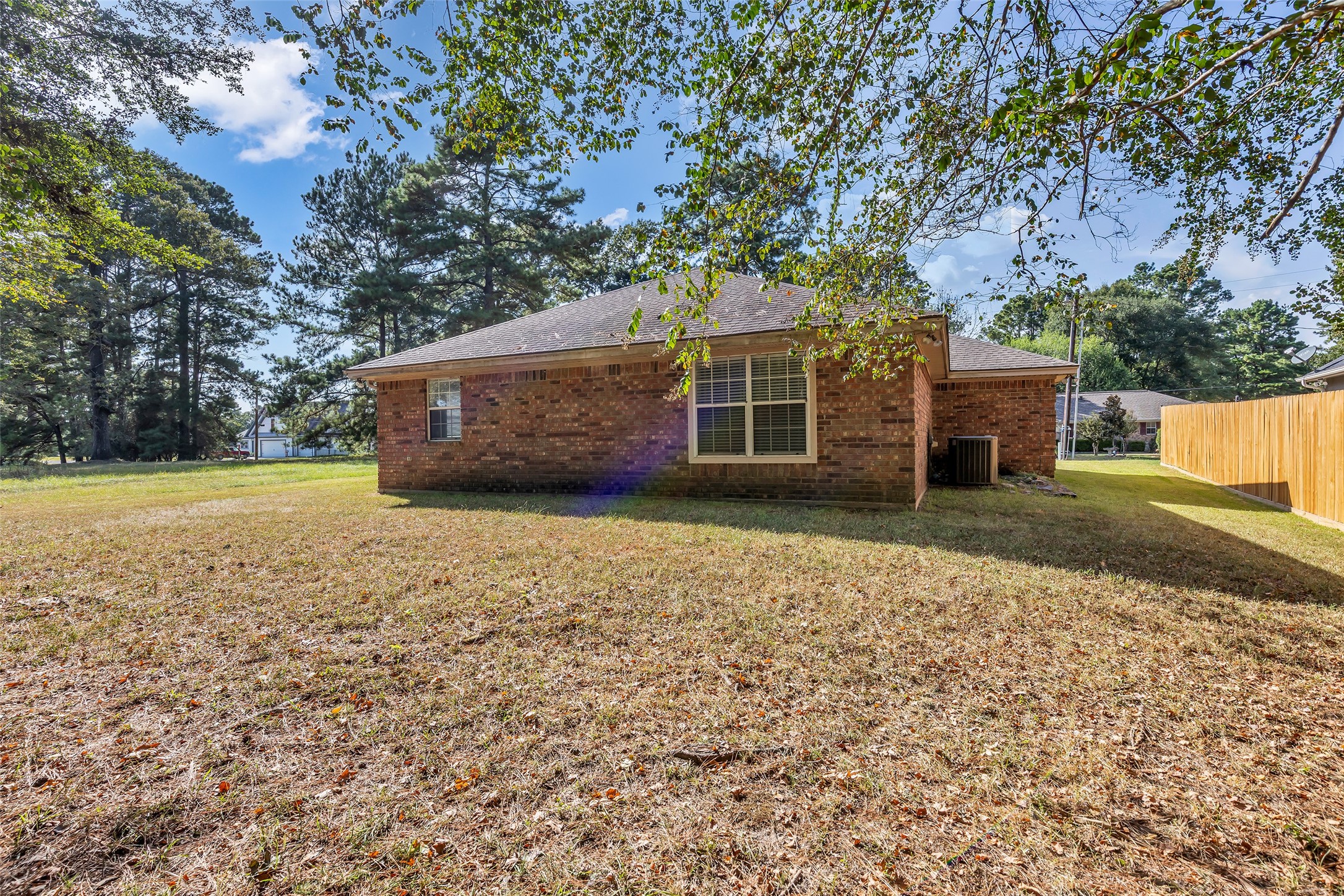 7 Lazy Spring Trinity, TX 75862 - Photo 22 of 25 Side yard with ample space for gardening, storage, or outdoor activities.