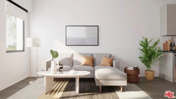 a living room with furniture a potted plant and a lamp