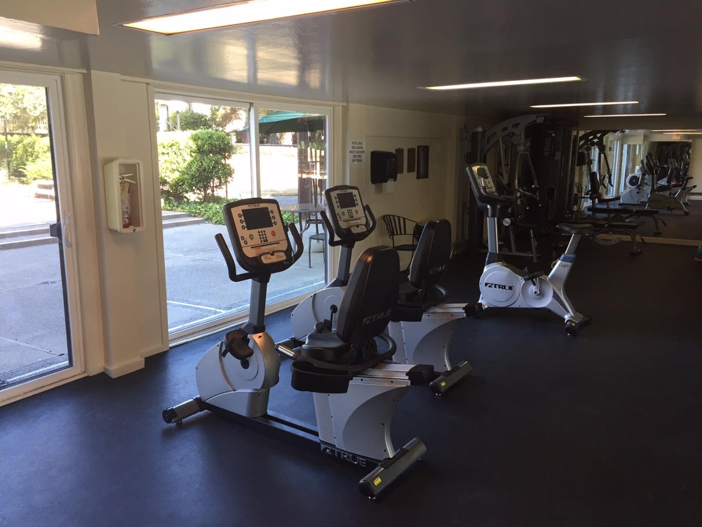 4117 George Avenue, Unit 4 San Mateo, CA 94403 - Photo 17 of 18 a room with gym equipment and large mirror