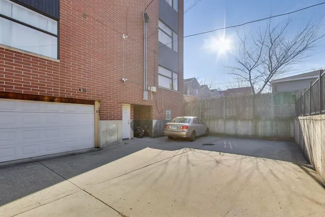 a front view of a building with parking space