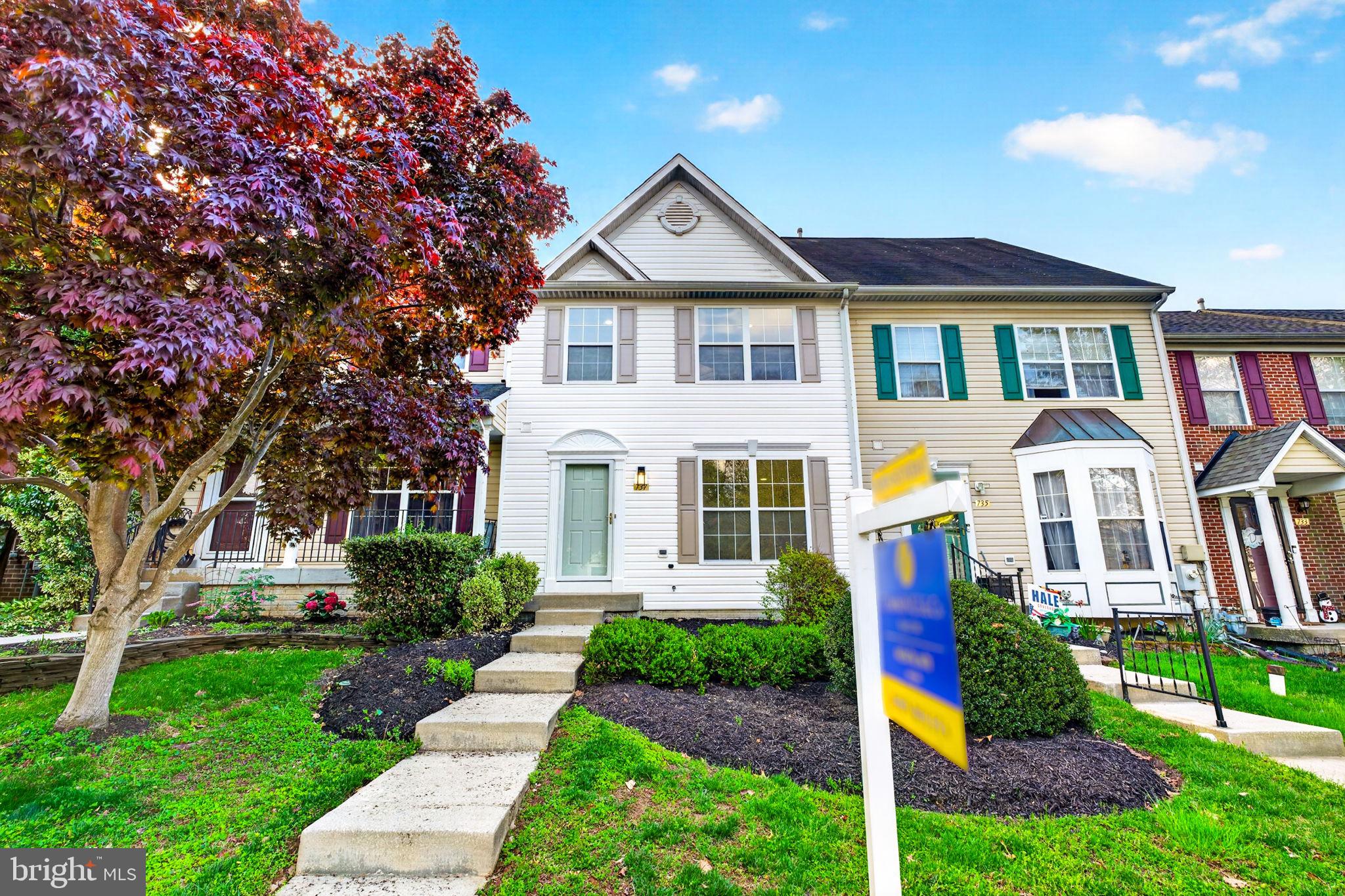 Charming home with vibrant landscaping.
