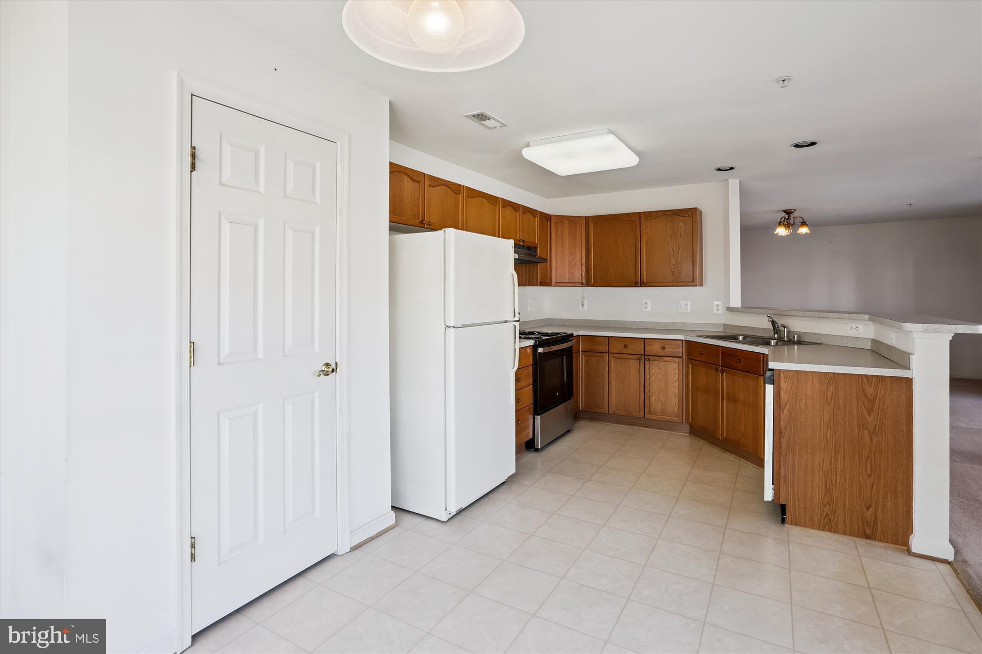 2500 Coleridge Drive, Unit 2A Frederick, MD 21702 - Photo 13 of 60 a kitchen with stainless steel appliances granite countertop a refrigerator and a sink