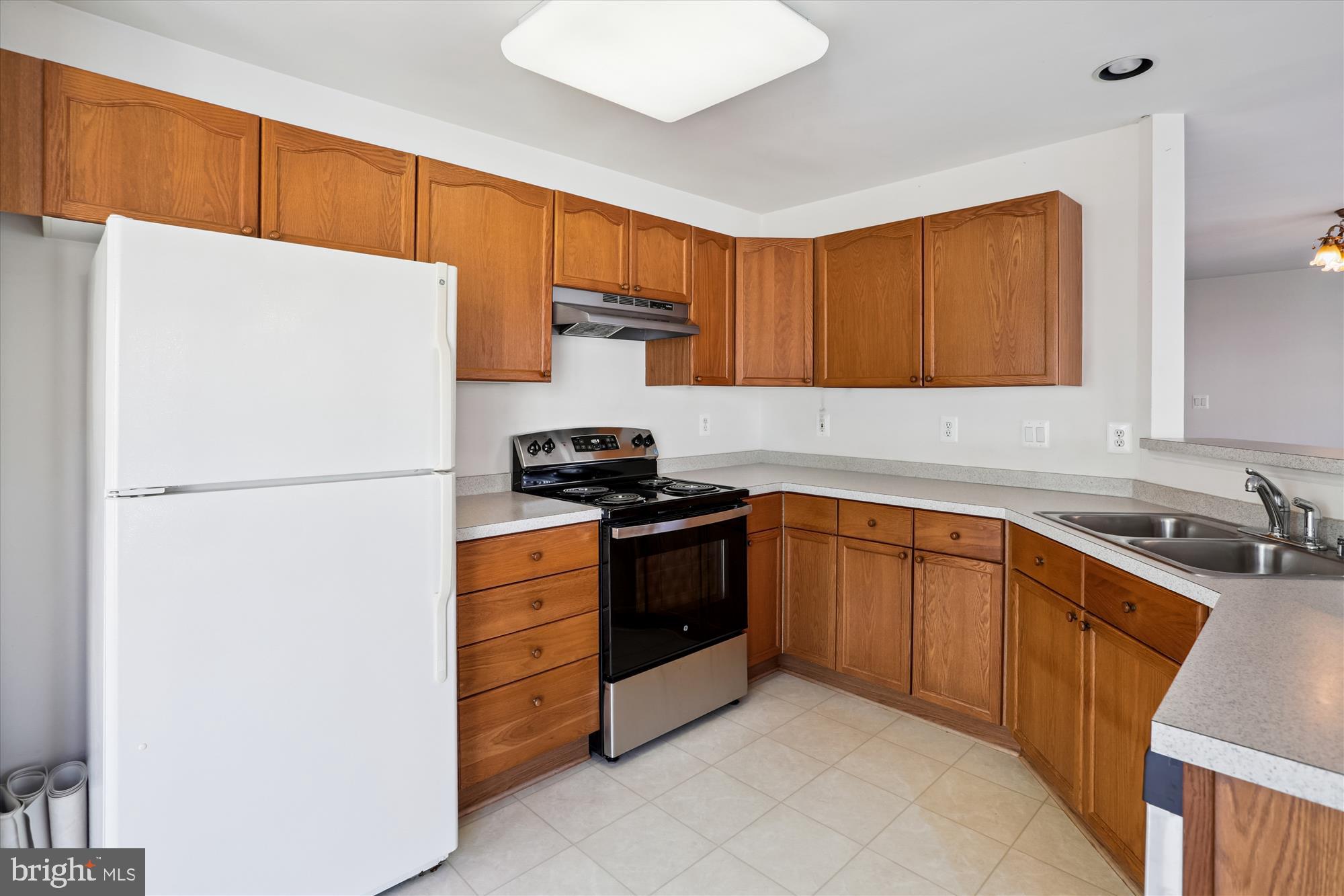 2500 Coleridge Drive, Unit 2A Frederick, MD 21702 - Photo 14 of 60 a kitchen with stainless steel appliances a refrigerator sink and cabinets