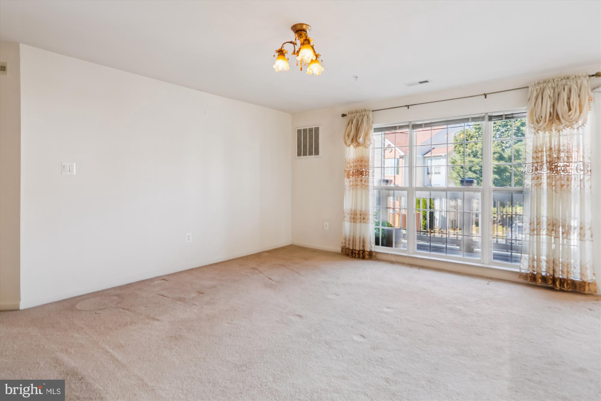 2500 Coleridge Drive, Unit 2A Frederick, MD 21702 - Photo 26 of 60 an empty room with floor to ceiling windows