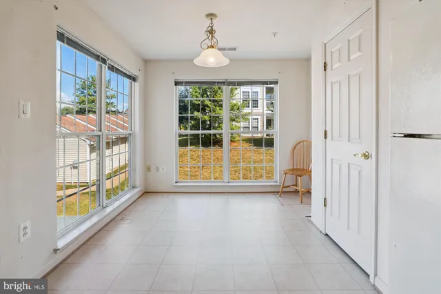 an empty room with window and ceiling fan