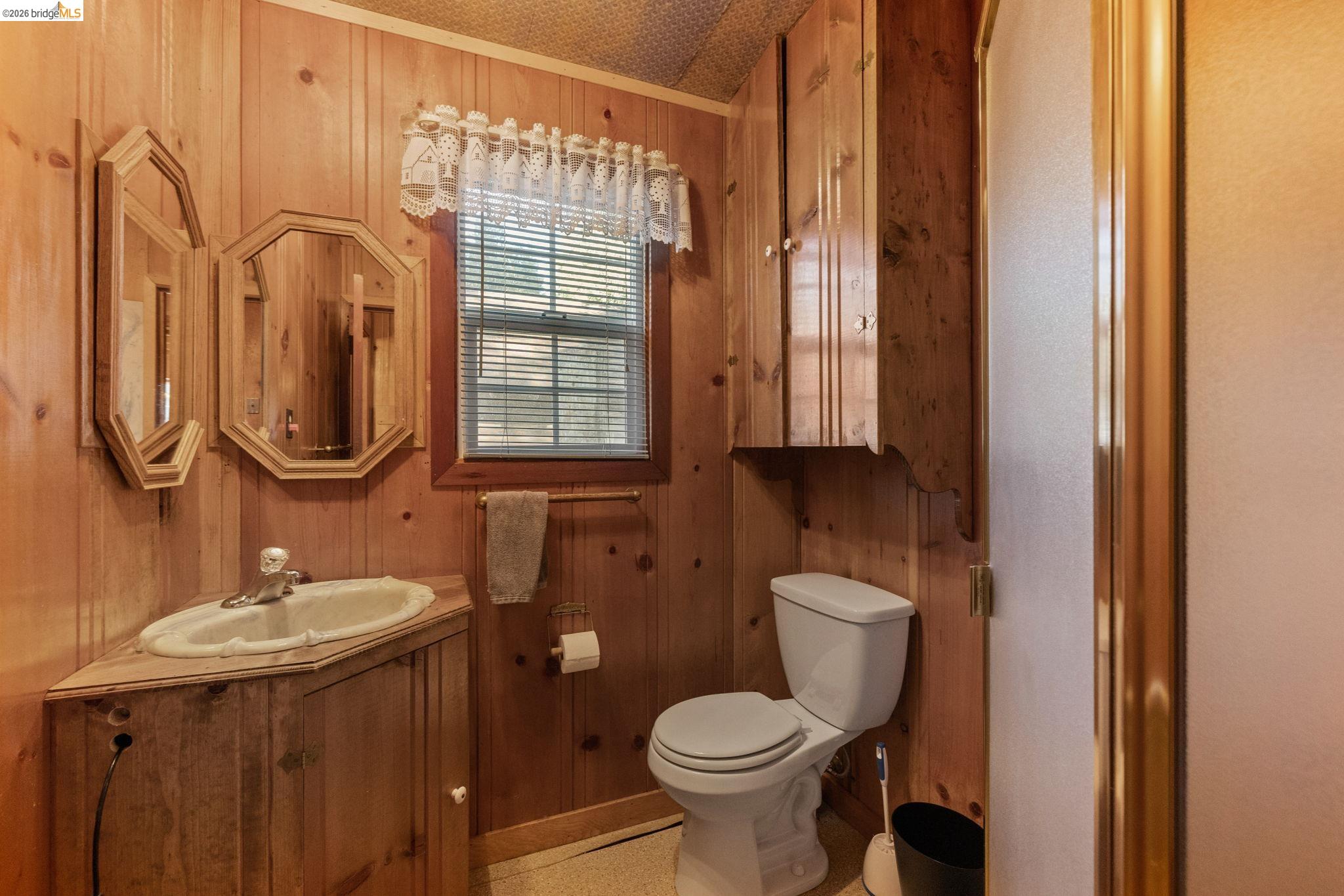 26175 Janice Way Long Barn, CA 95335 - Photo 13 of 23 Full bathroom with wood walls and vanity