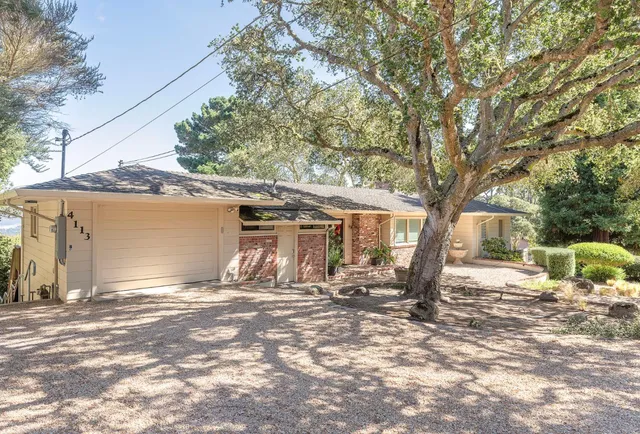 a backyard of a house with yard and outdoor seating