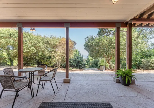 a view of a patio with a table chairs and a table