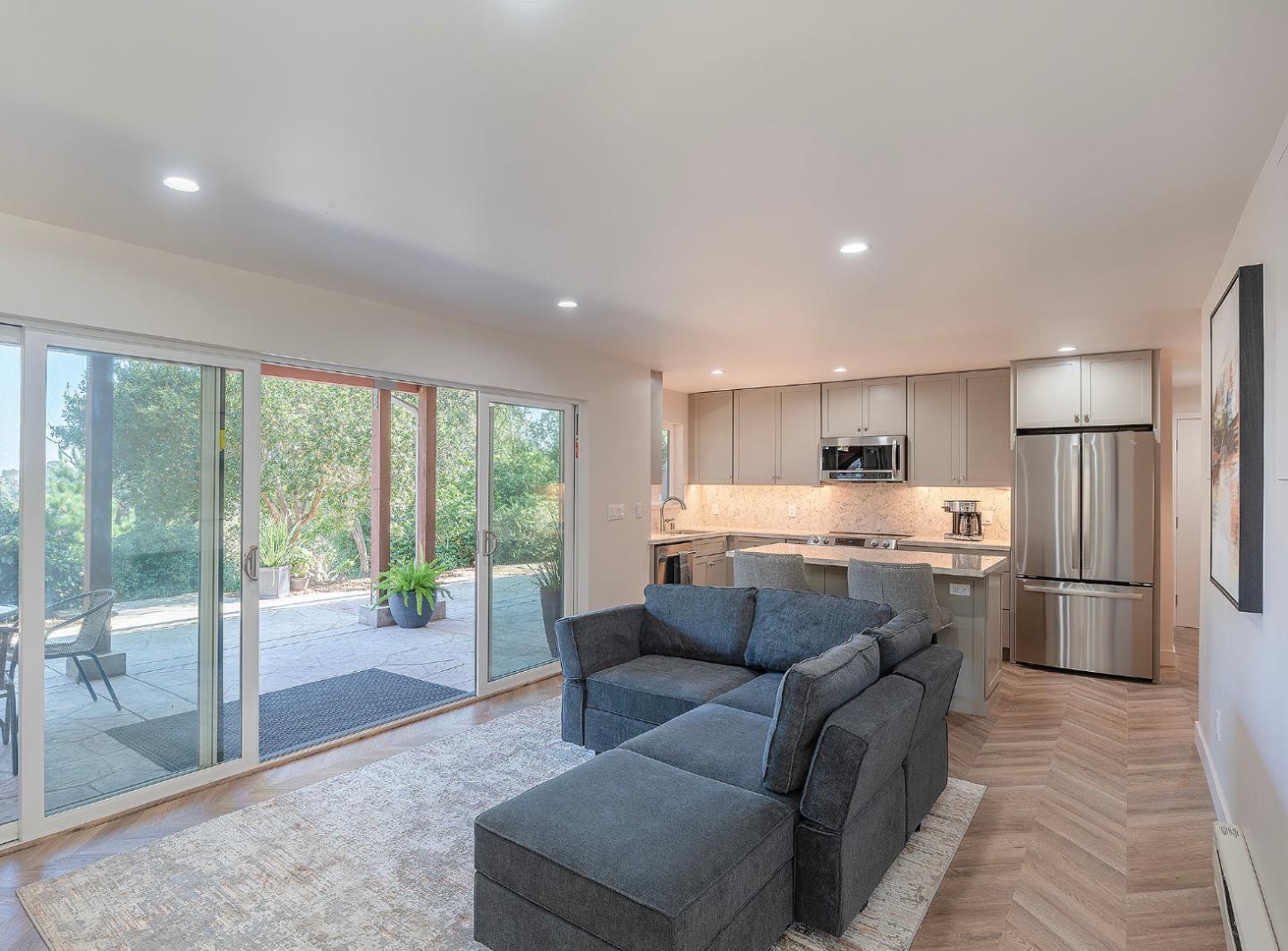 4113 Crest Road Pebble Beach, CA 93953 - Photo 3 of 15 a living room with stainless steel appliances kitchen island granite countertop a refrigerator a sink dishwasher with a dining table and chairs