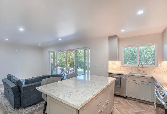 a kitchen with a stove a sink and a refrigerator