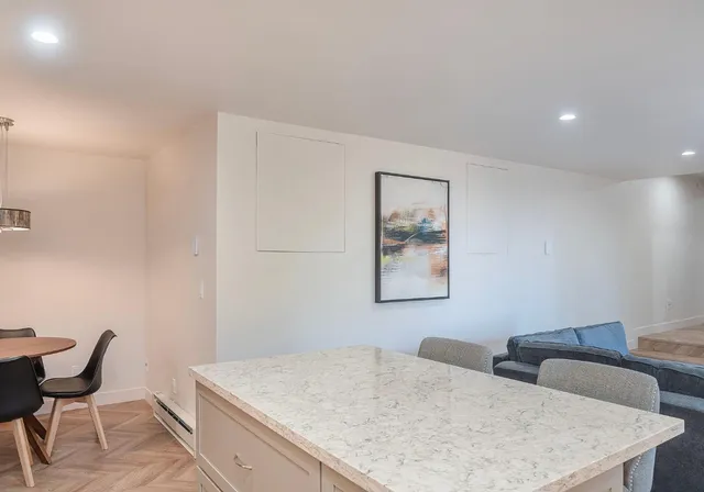 a view of a room that has a couch and chair in it