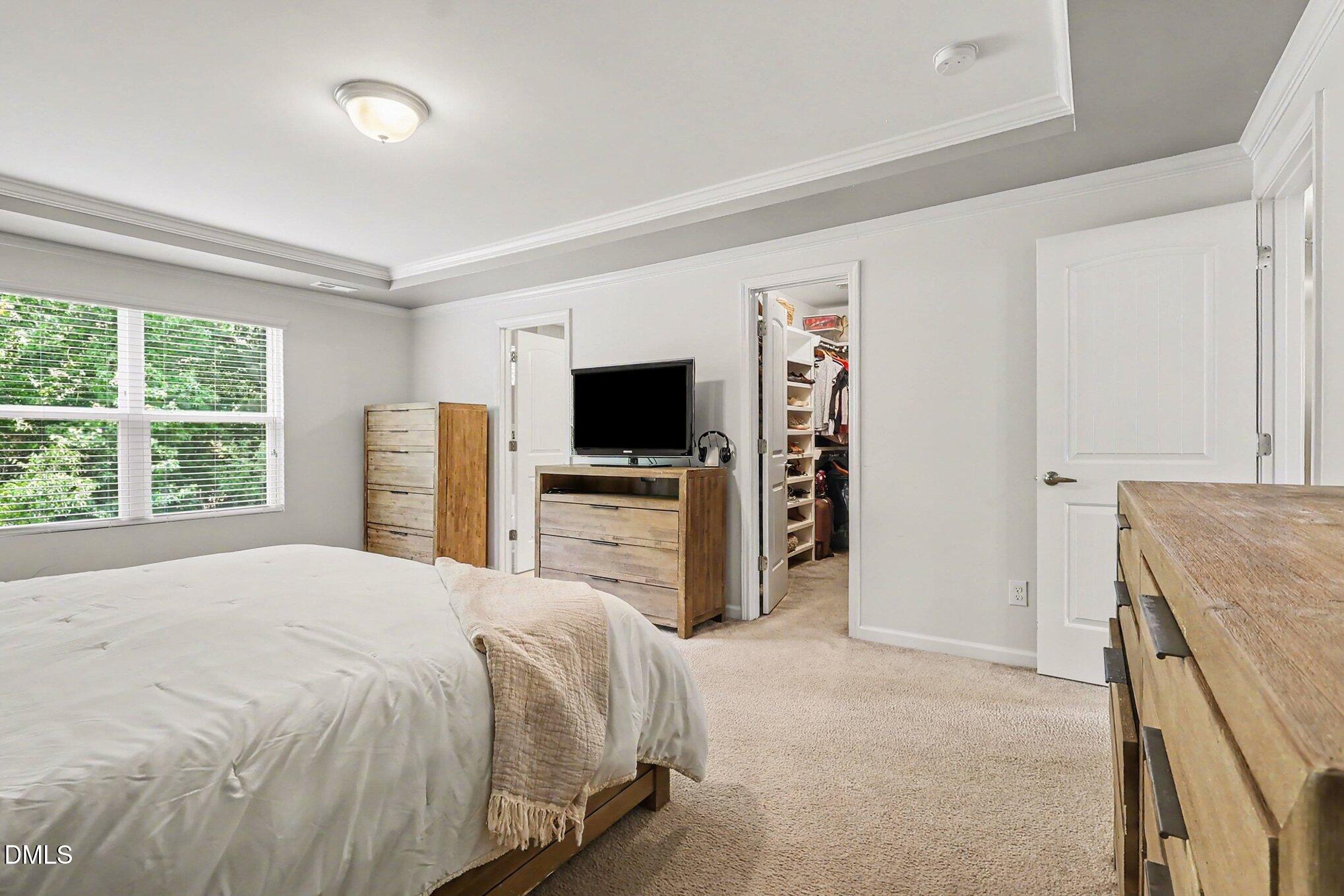 4366 Auburn Hills Drive Raleigh, NC 27616 - Photo 15 of 40 a bedroom with a bed and a flat screen tv