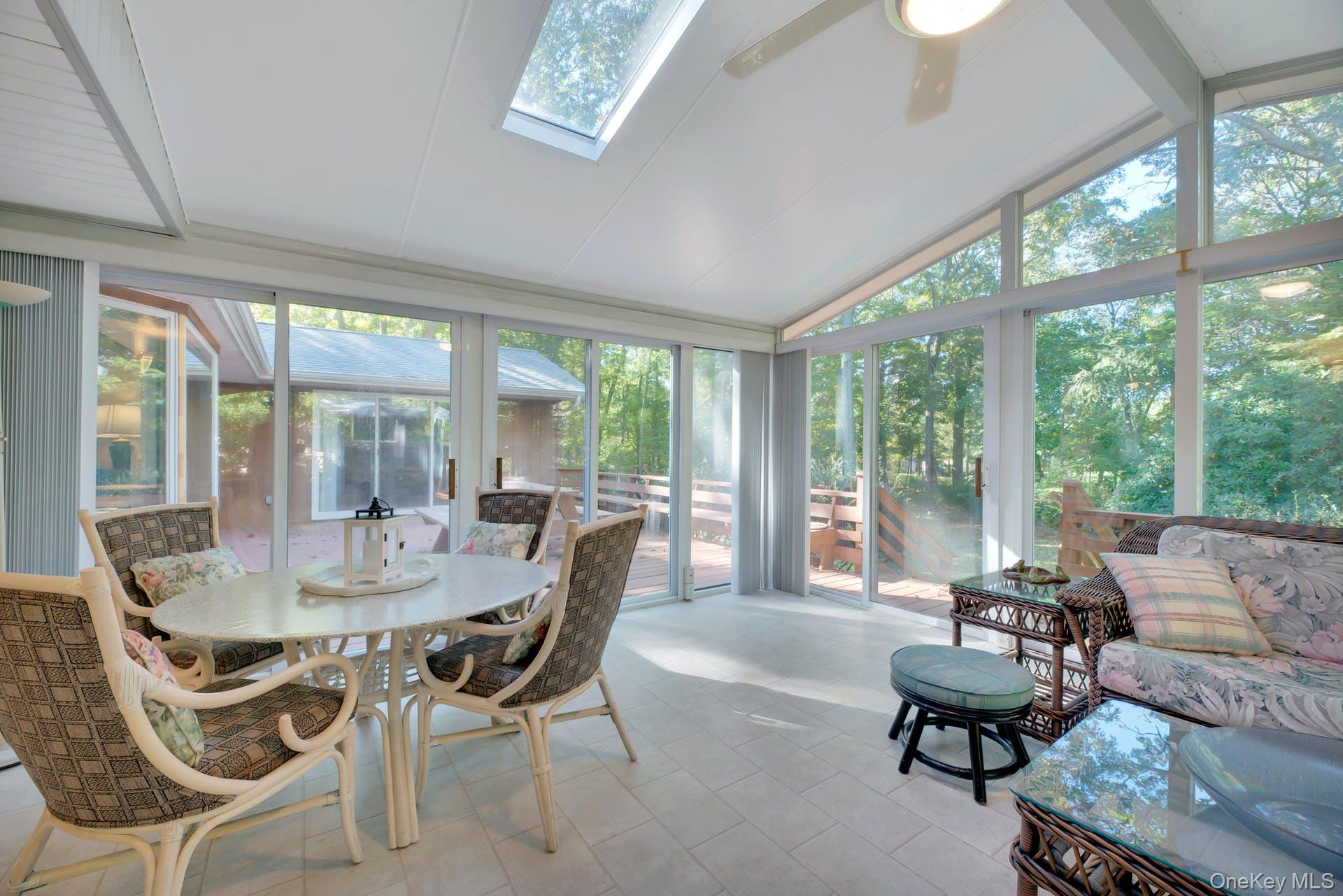 1075 Inlet Lane Greenport, NY 11944 - Photo 11 of 30 a dining room with furniture and large windows