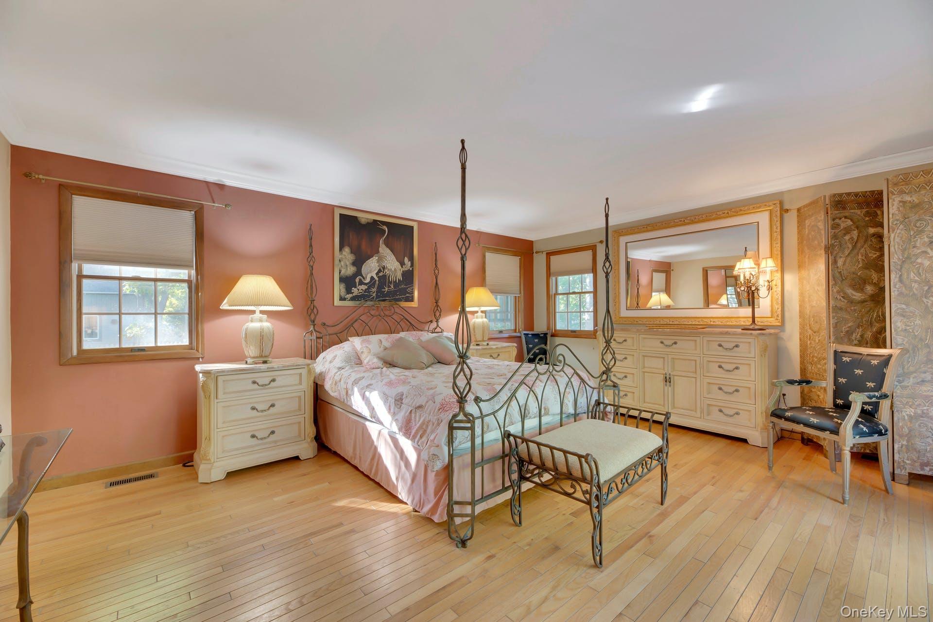 1075 Inlet Lane Greenport, NY 11944 - Photo 12 of 30 a spacious bedroom with a bed and wooden floor