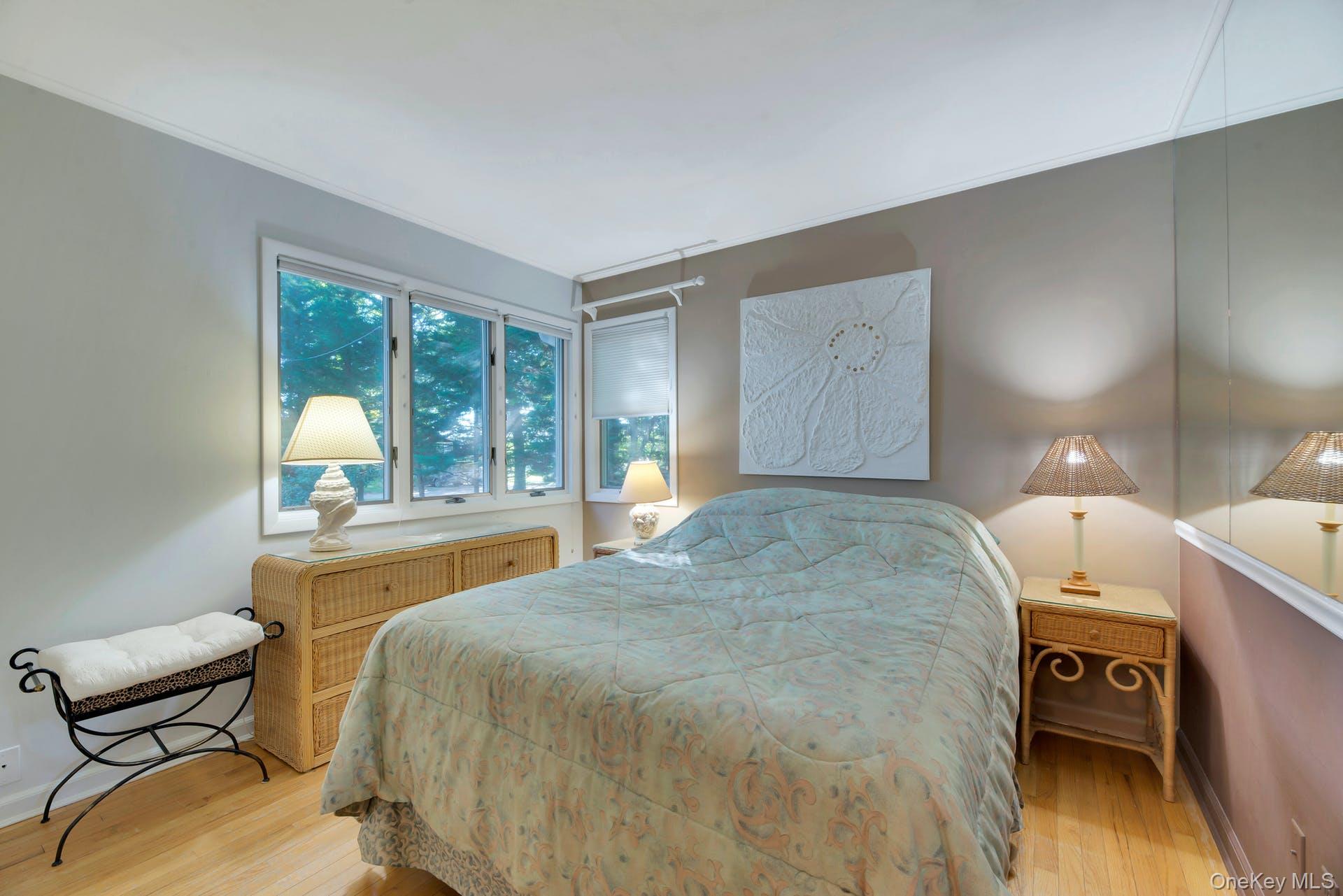 1075 Inlet Lane Greenport, NY 11944 - Photo 17 of 30 a bedroom with a bed and large windows