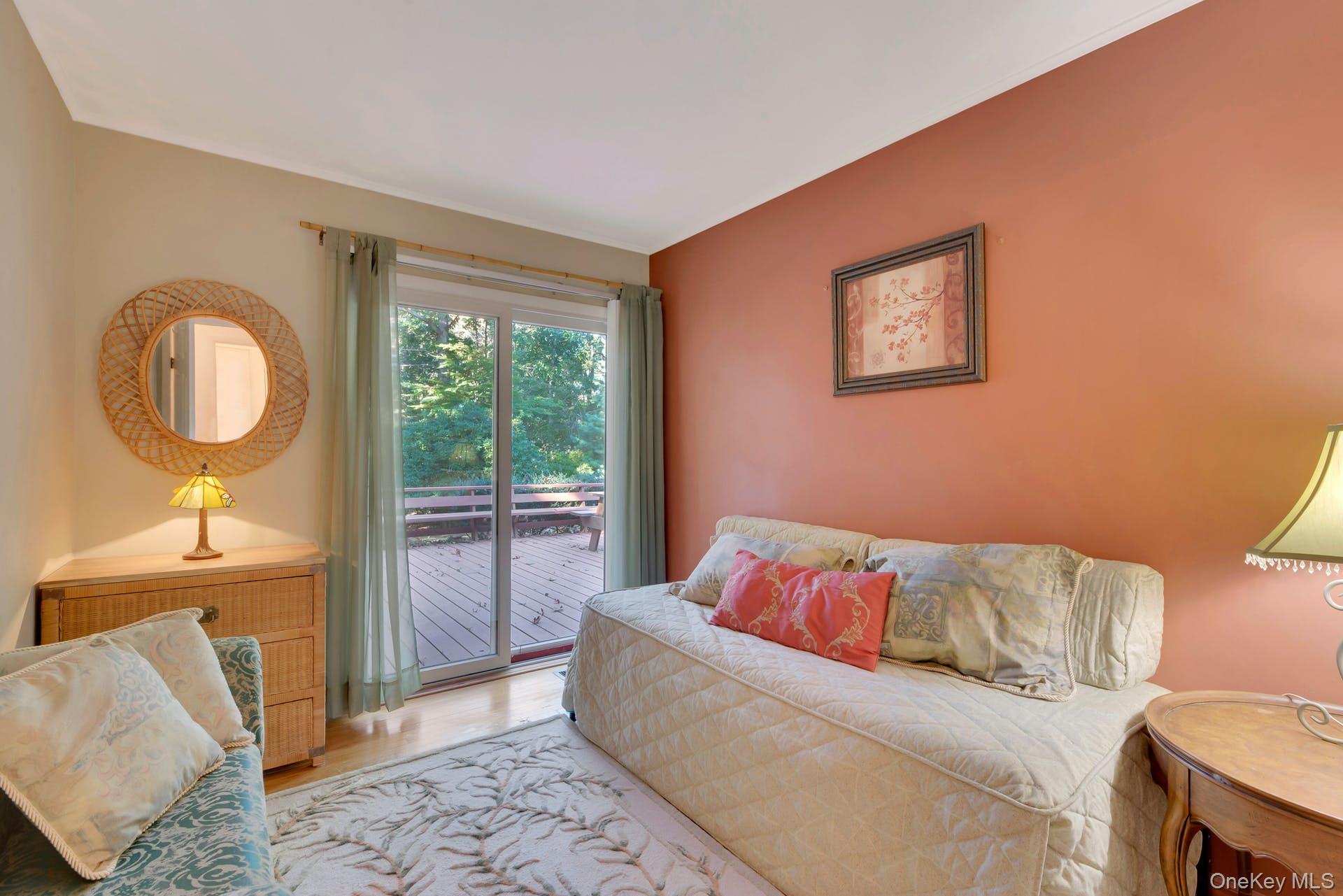 1075 Inlet Lane Greenport, NY 11944 - Photo 18 of 30 a bedroom with a bed and a mirror