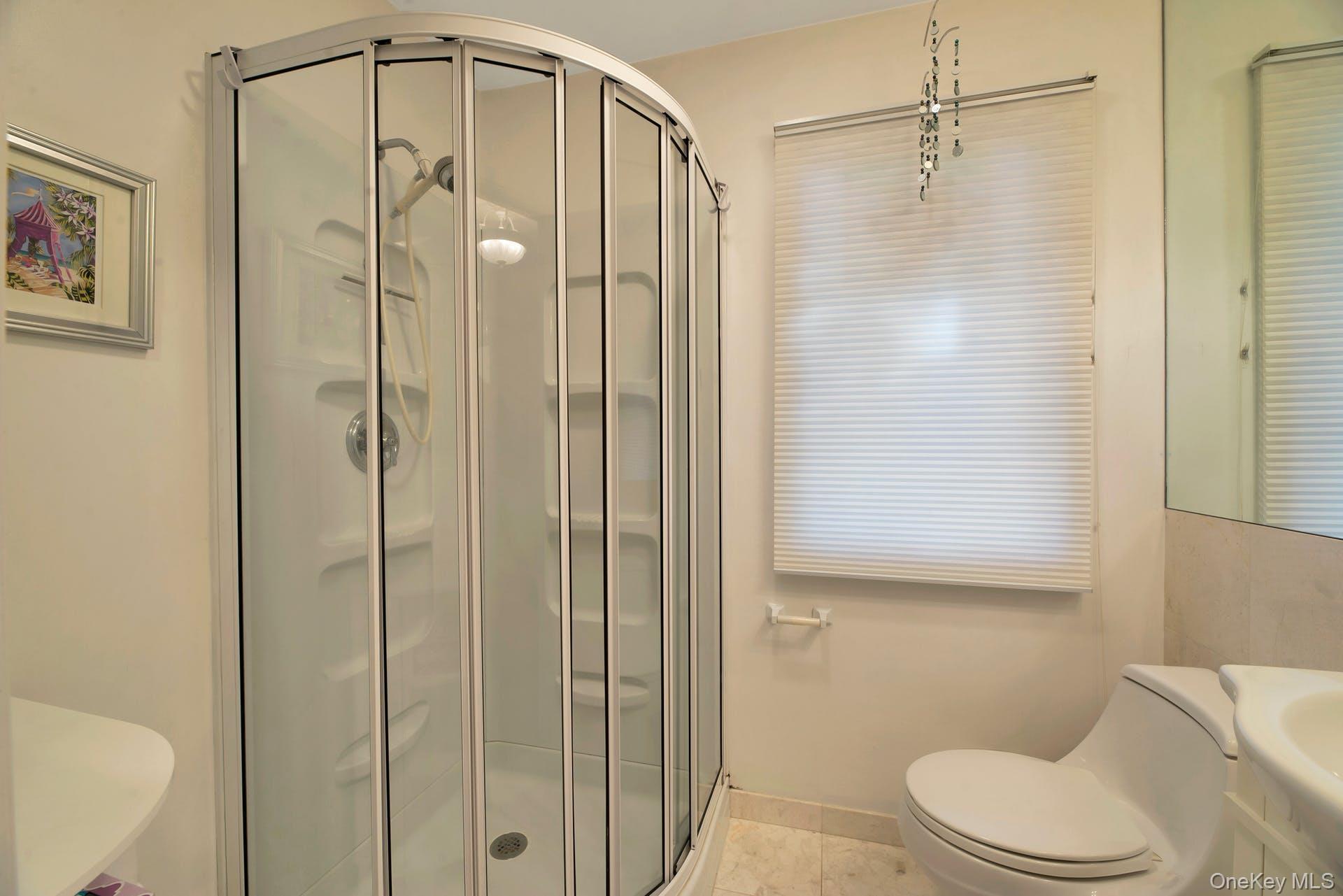 1075 Inlet Lane Greenport, NY 11944 - Photo 19 of 30 a bathroom that has a glass shower door