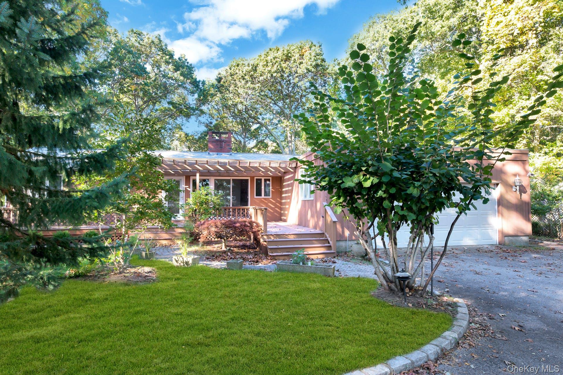 1075 Inlet Lane Greenport, NY 11944 - Photo 2 of 30 a front view of a house with garden