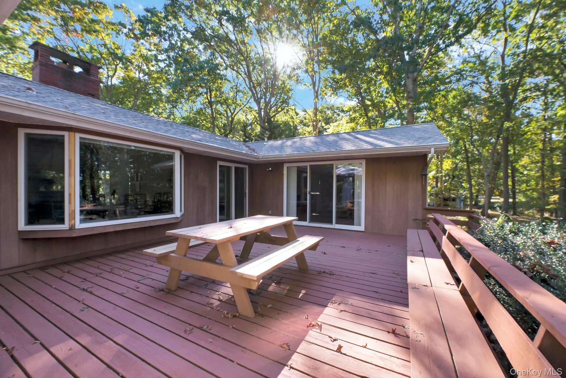 1075 Inlet Lane Greenport, NY 11944 - Photo 21 of 30 a front view of house with deck outdoor seating and green space