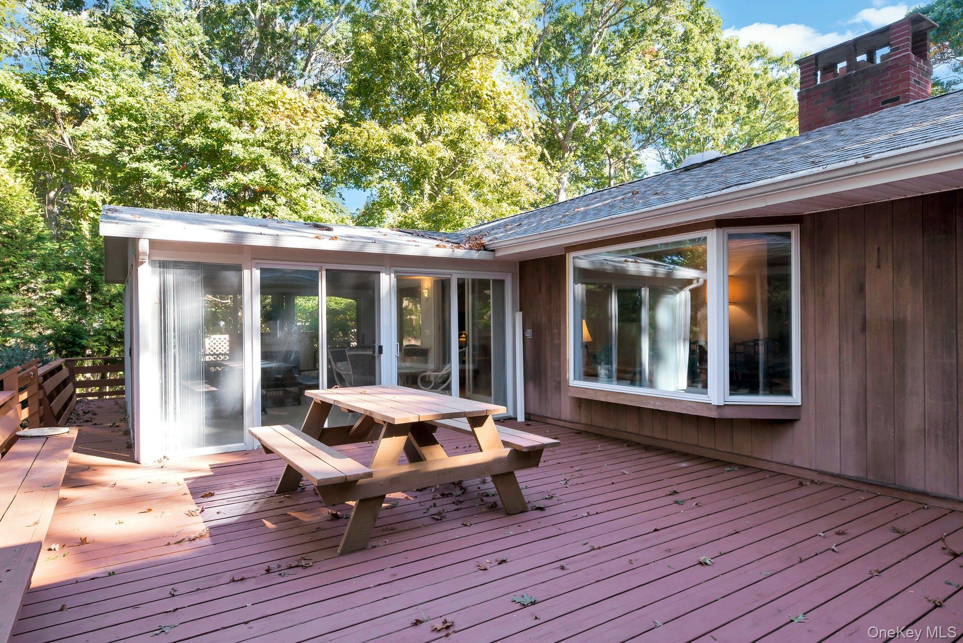 1075 Inlet Lane Greenport, NY 11944 - Photo 22 of 30 Wooden deck with outdoor dining area