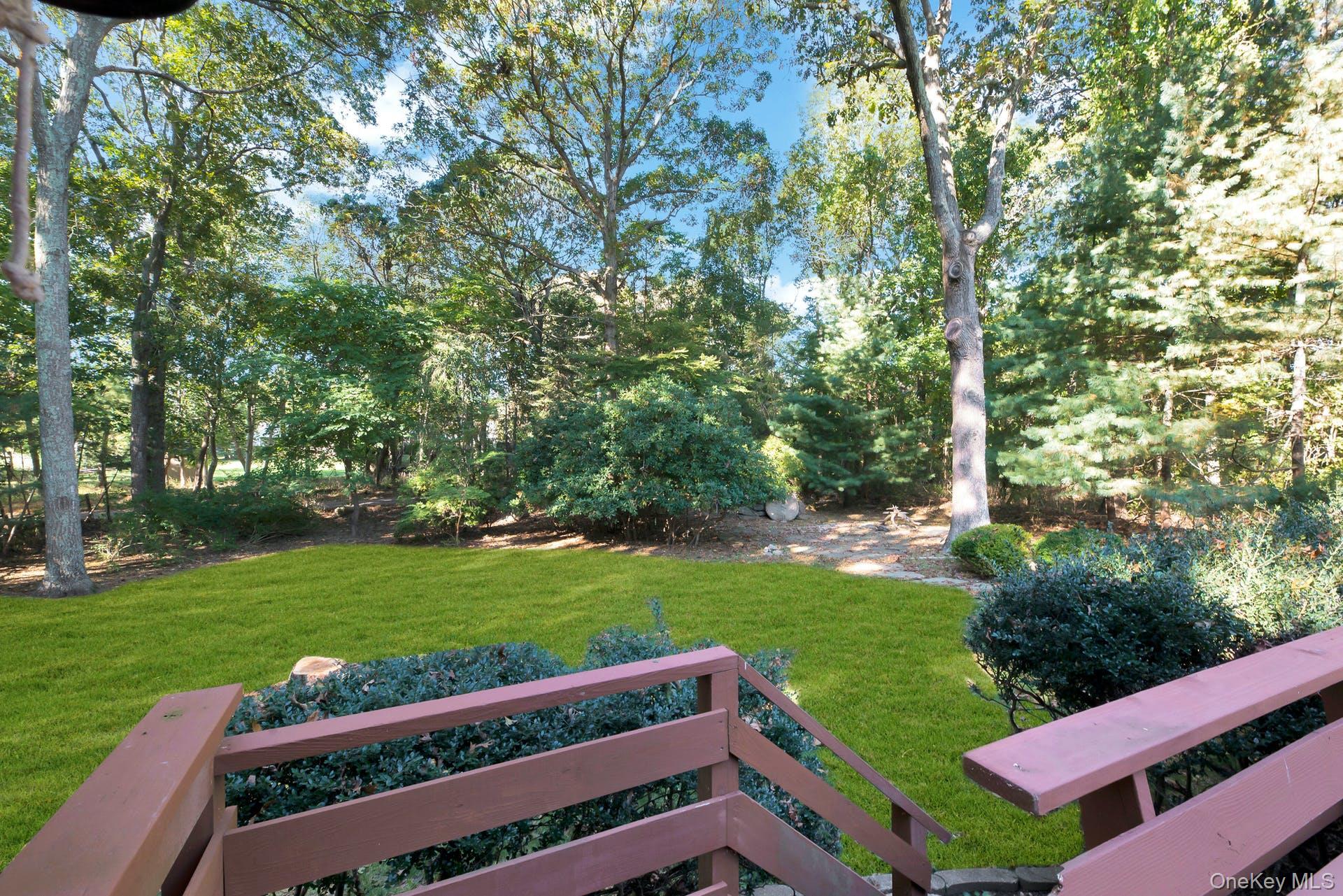 1075 Inlet Lane Greenport, NY 11944 - Photo 23 of 30 a view of a yard with wooden fence