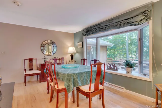 a dining room with furniture a rug and a large window