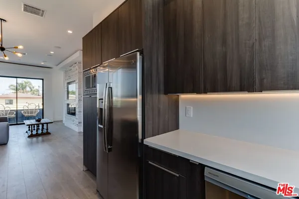 a stove top oven sitting inside of a kitchen