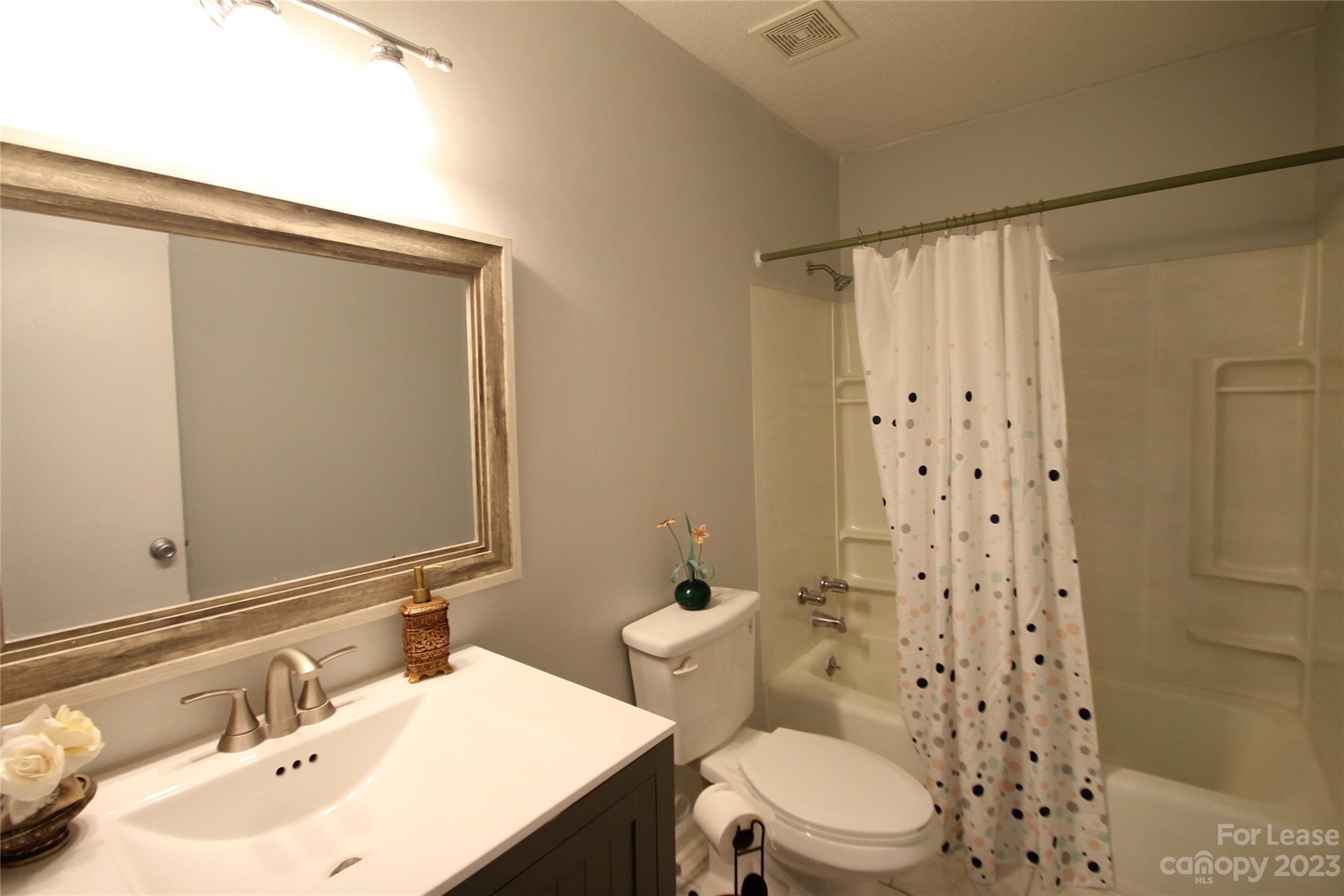 1788 Ebenezer Road Rock Hill, SC 29732 - Photo 21 of 30 a bathroom with a sink a toilet a shower and a mirror