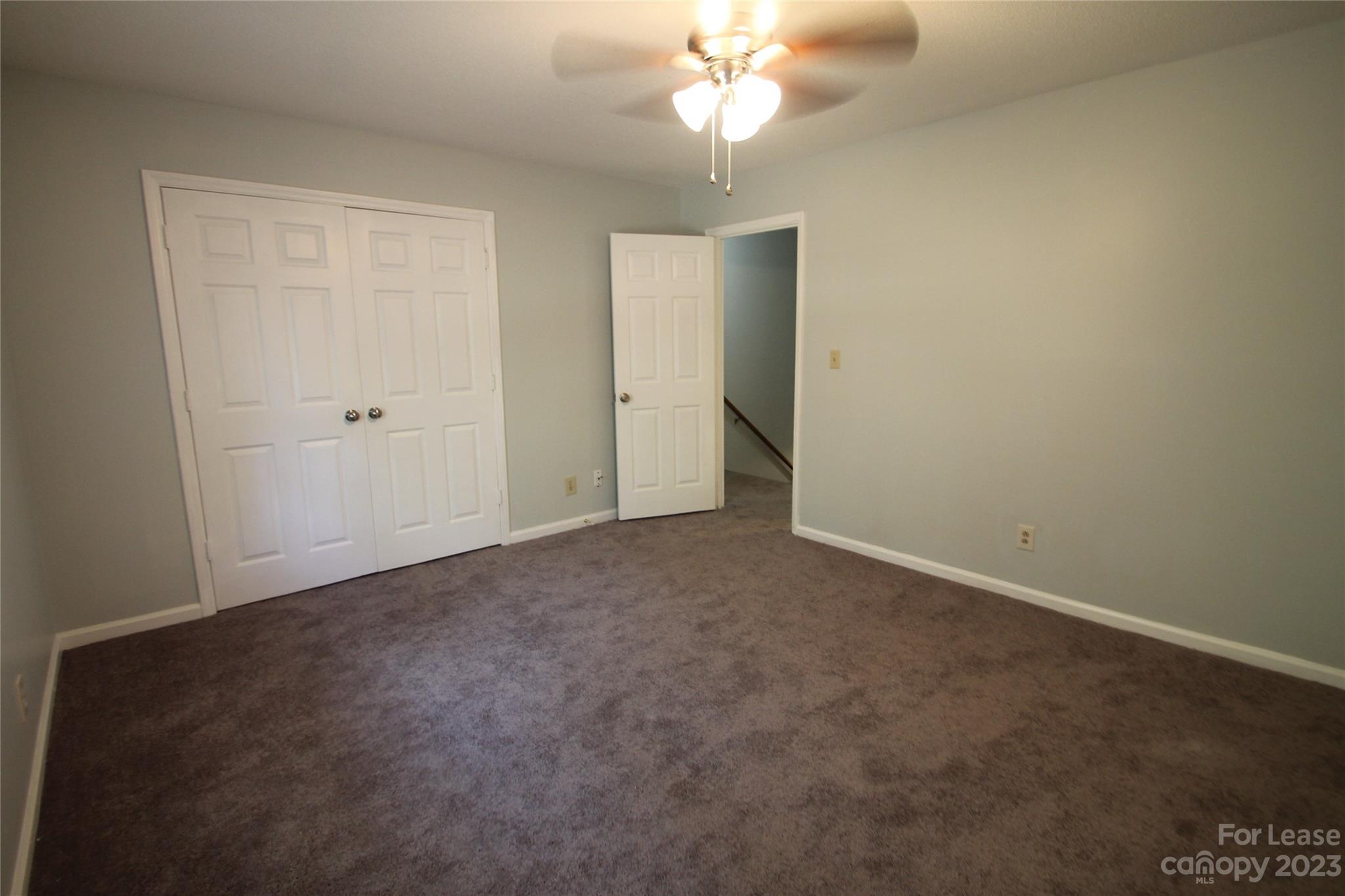 1788 Ebenezer Road Rock Hill, SC 29732 - Photo 25 of 30 an empty room with a chandelier fan and closet area