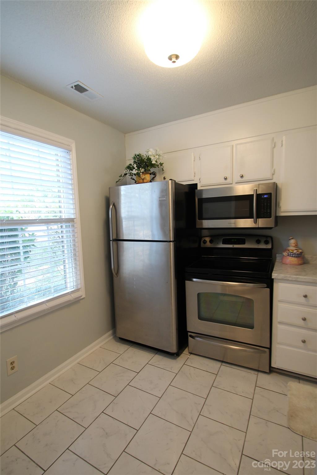 1788 Ebenezer Road Rock Hill, SC 29732 - Photo 5 of 30 a kitchen with a refrigerator and a stove top oven