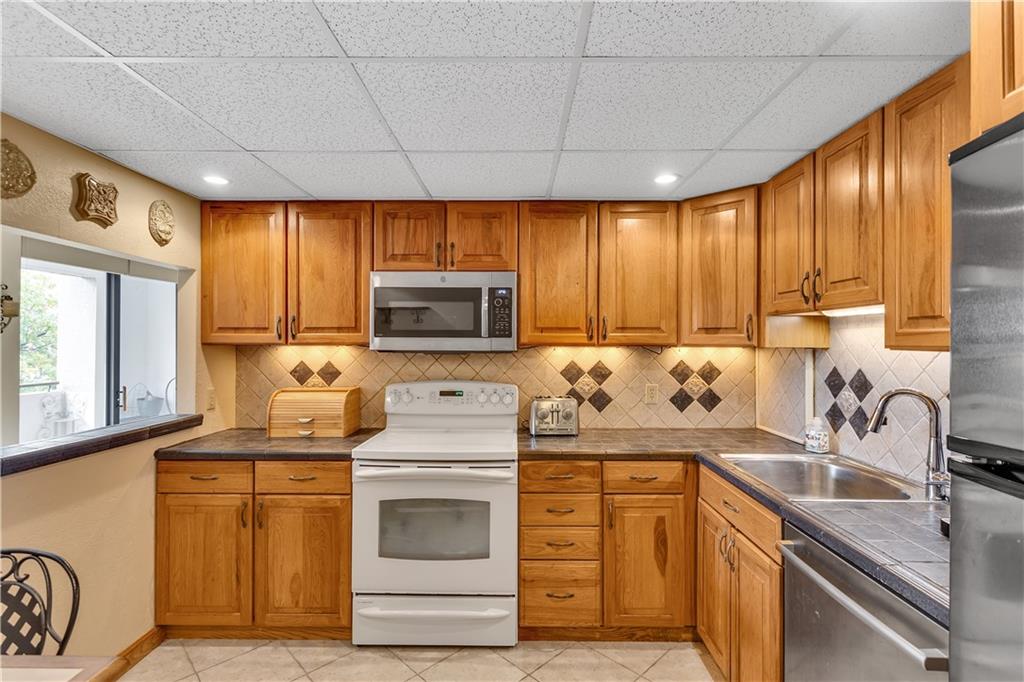 900 Washington Road, Unit 412 Pittsburgh, PA 15228 - Photo 12 of 34 a kitchen with kitchen island granite countertop a sink stainless steel appliances and cabinets